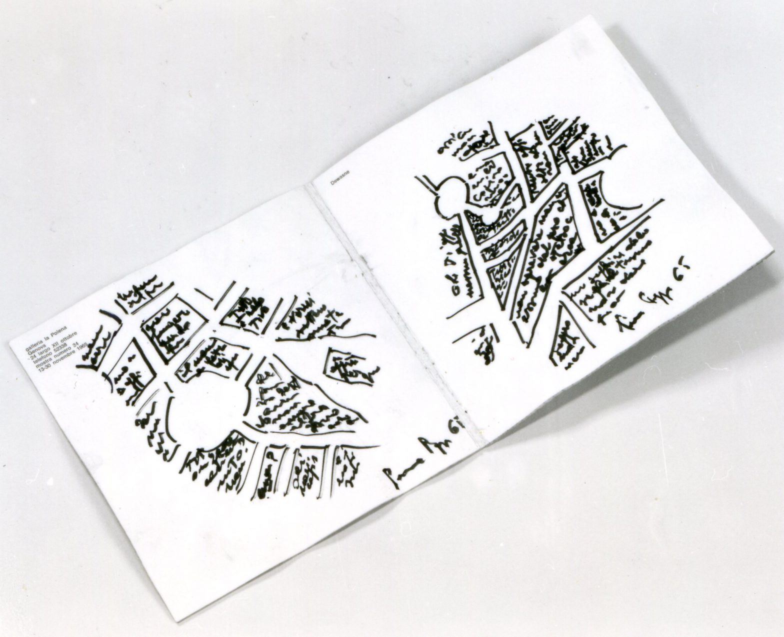 Opened reused foBookpages show sketches of city maps.